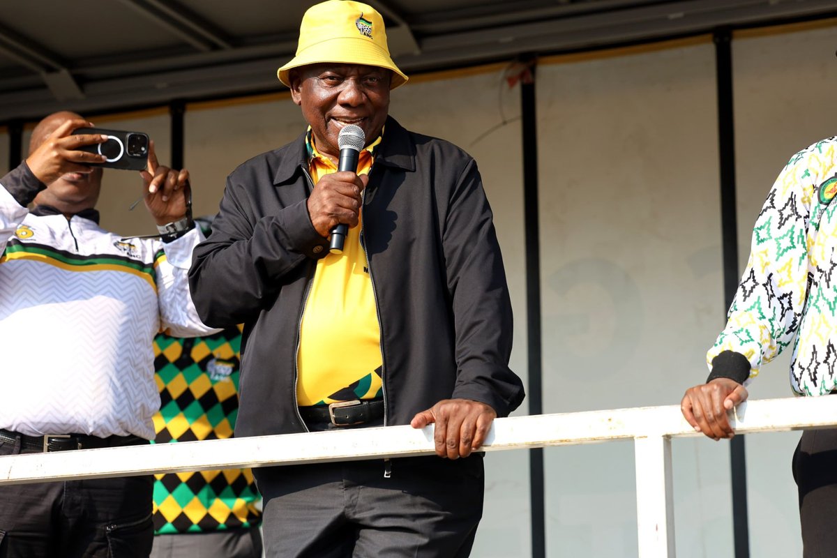 Cyril Ramaphosa speaking into a microphone during campaign work in Ekurhuleni.