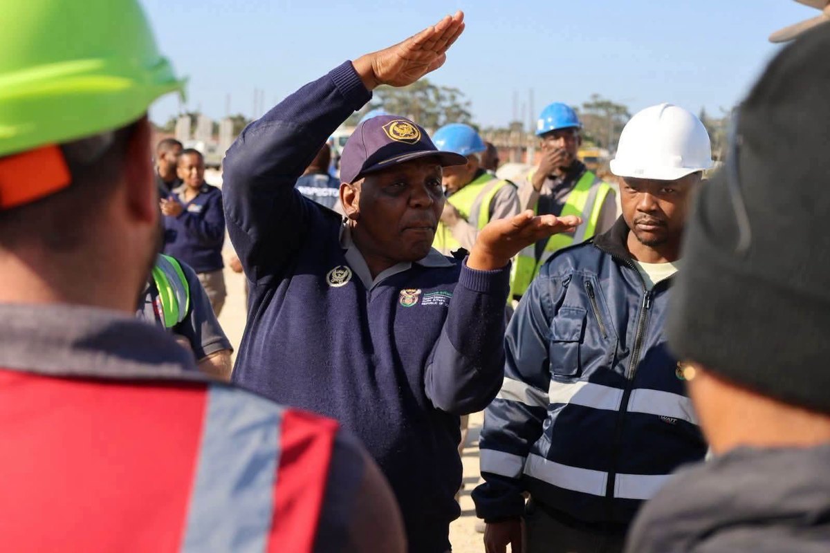 Officials conduct checks at a construction site during the coordinated compliance operation