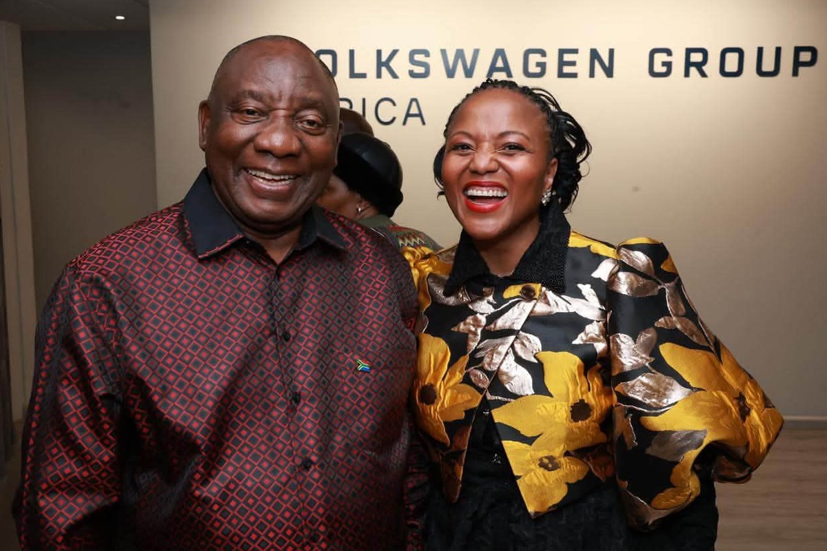 President Cyril Ramaphosa and Nelson Mandela Bay Executive Mayor Babalwa Lobishe laughing together at the Volkswagen Group Africa head office wall signage