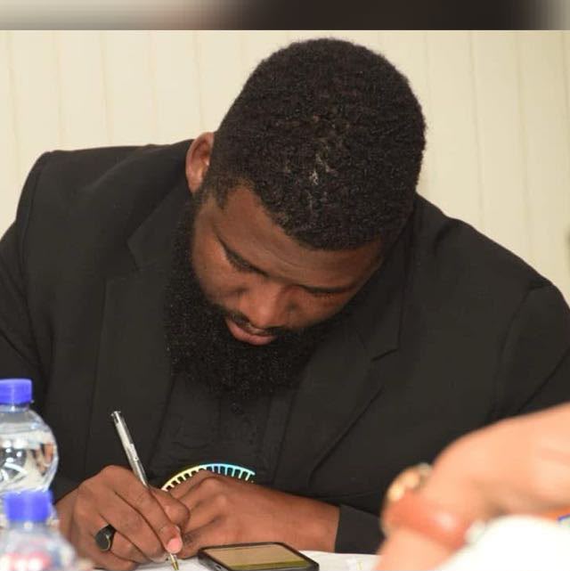 Bamanye Matiwane writing during a working session
